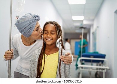 Sick Woman With Cancer Hugging Her Young Grandchild In Hospital. Family Support Concept.