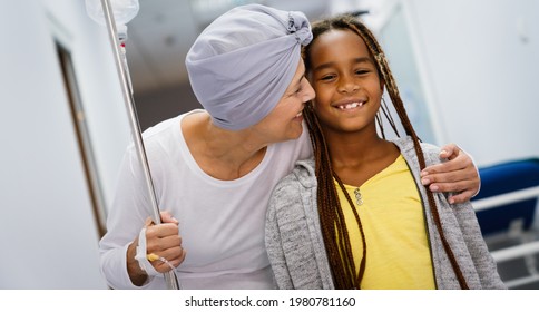 Sick Woman With Cancer Hugging Her Young Grandchild In Hospital. Family Support Concept.