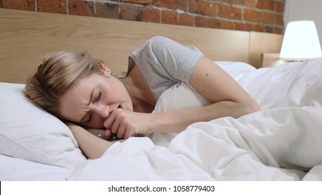 Sick Woman Coughing Lying In Bed On Side, Cough