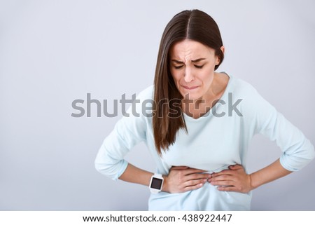 Sick woman having a stomach ache