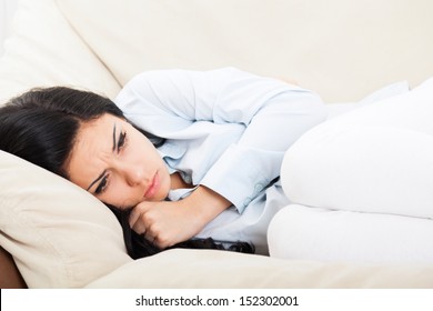 Sick Woman, Ill, Stomach Ache Female Hold Hand On Stomach, Young Unhealthy Girl Pain Lying At Home On Sofa Couch