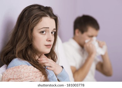 Sick woman and man have cold, flu and high fever.