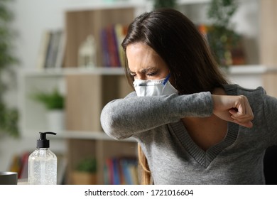 Sick Woman With Mask Coughing On Elbow Due Coronavirus Infection At Home In The Night