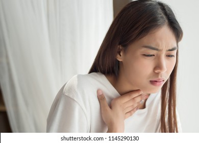 Sick Woman With Sore Throat; Portrait Of Woman Suffering From Cold, Flu, Sickness With Sore Throat Inflammation; Woman Health Care, Body Care, Sickness, Pain Concept; Asian Young Adult Woman Model