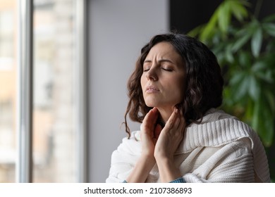 Sick Woman Suffer From Sore Throat Touch Enlarged Lymph Nodes Staying Home On Sick Leave. Unhappy Young Female With Coronavirus Disease, Angina Or Pharyngitis Illness Symptoms. Girl Feeling Discomfort