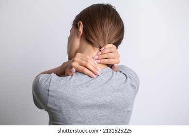 Sick woman suffering from sore neck on gray background - Shutterstock ID 2131525225