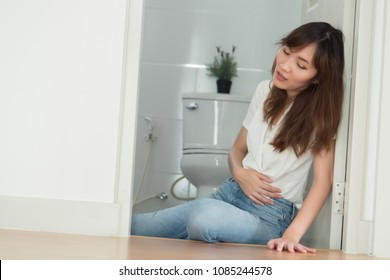 Sick Woman In Toilet Or Wc With Stomachache; Sick Woman Suffer From Stomachache, Gastritis, Flatulence, Appendicitis, Colon Cancer, Stomach Cancer, Gastric Cancer; Asian Adult Woman Health Care Model