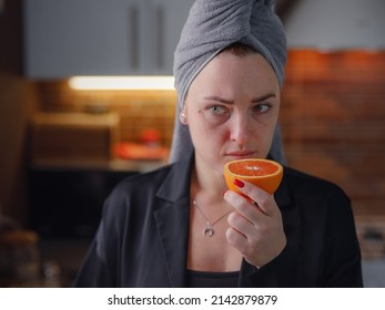 Sick Woman Trying To Sense Smell Of Fresh Orange, Has Symptoms Of Covid-19, Corona Virus Infection. Long-lasting Covid19 Symptom. Loss Of Taste Of Food. Loss Of Smell As One Of Long-term Sars-cov-2