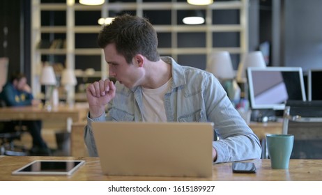 The Sick Young Male Designer Coughing In Modern Office