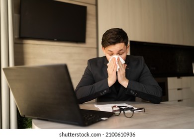 Sick Young Man At Work Got Allergic To Flu, Sneezing And Fasting, Wiping A Runny Nose With A Paper Napkin, Allergic Guy Caught A Cold At Work, Respiratory Illness Sitting In Home Office, Sick Leave