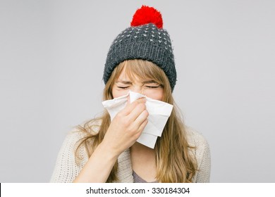 Sick Young Woman Blowing Her Nose Isolated On Light Background