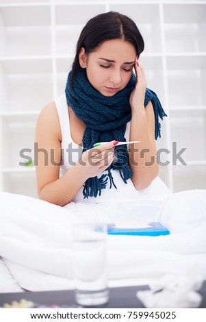 Sick young woman is coughing on the bed