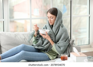 Sick Young Woman Eating Chicken Soup At Home