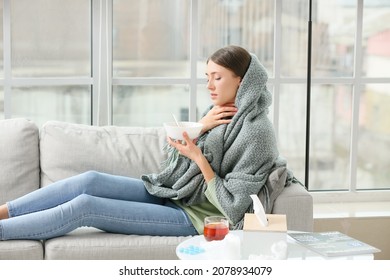 Sick Young Woman Eating Chicken Soup At Home