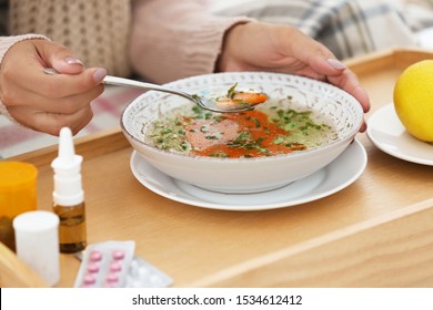 Sick Young Woman Eating Soup To Cure Flu, Closeup