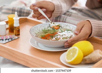 Sick Young Woman Eating Soup To Cure Flu, Closeup