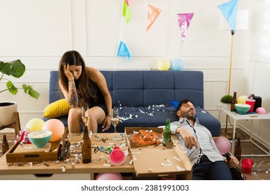 Sick young woman with a headache and nausea looking hangover with an unconscious man after celebrating drinking during a birthday party