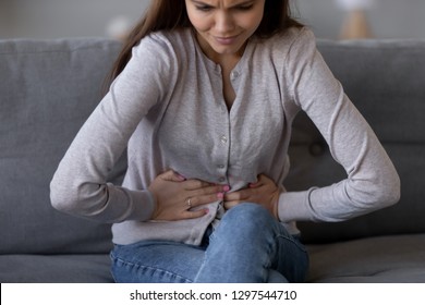 Sick Young Woman In Pain Holding Belly Stomach Feeling Hurt Abdomen Ache Gastritis Pancreatitis Symptoms Or Diarrhea, Upset Teen Girl Suffering From Indigestion Flatulence Abdominal Problem Concept