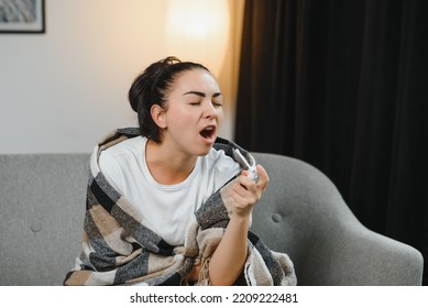 Sick Young Woman In Scarf Using Cough Spray