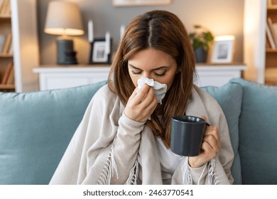 Sickness, seasonal virus problem concept. Woman being sick having flu lying on sofa. Sick woman lying in bed with high fever. Cold flu and migraine. - Powered by Shutterstock