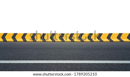 Side angle view of asphalt racing track with yellow and black color arrow concrete railing