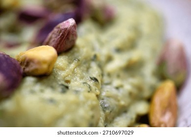 Side Angle View Of A Bowl Filled With Thick Green Pistachio Dip Garnished With Whole Nuts Served As A Premium Quality Confectionery Product Or Morning Meal Accompaniment