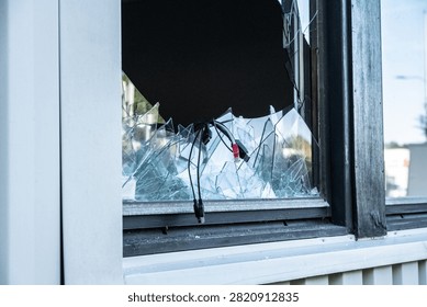 Side angle view of broken office window with glass shards