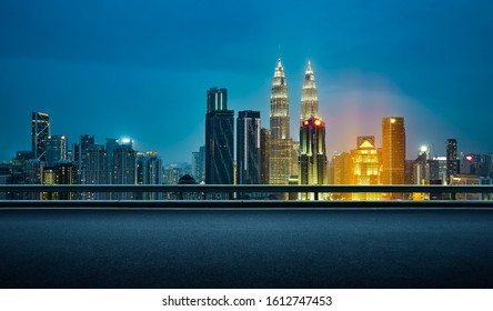 Side Angle View Of Empty Asphalt Road With Beautiful Night Cityscape Scene . Photo Manipulation .