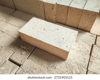 Side angle view of refractory firebrick installed on an industrial platform. Heat resistant construction material designed for high temperature industrial processes.