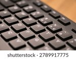Side Angled Top View Macro Close-Up Black Computer Keyboard Highlighting R Key with Soft Blurred Tech Backgrounds