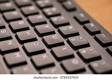 Side Angled Top View Macro Close-Up Black Computer Keyboard Highlighting U Key with Soft Blurred Tech Backgrounds
