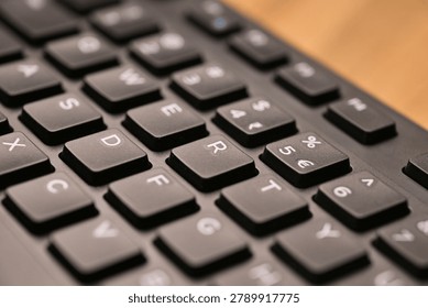 Side Angled Top View Macro Close-Up Black Computer Keyboard Highlighting R Key with Soft Blurred Tech Backgrounds