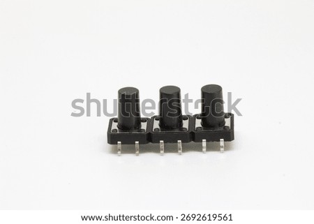 Side angled view of three long-stem tactile pushbutton switches showing four-pin leads for PCB mounting, isolated on white