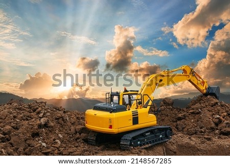 Side and back view of excavator  are digging soil in the construction site on sky and sunbeam background