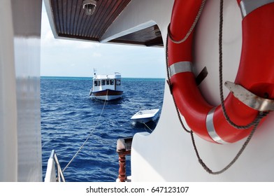 Side Boat View Of Live-aboard Diving With Life Ring And Small Boat, Maldive.