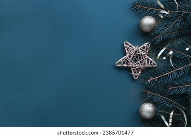 Side border of Christmas frame made of fir branches, golden decorative stars, balls on blue background. Flat, top view. Christmas banner mockup with copy space.jpg