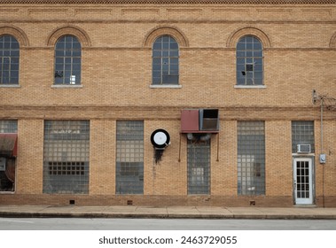 The side of a brick building with unique features in rural Oklahoma