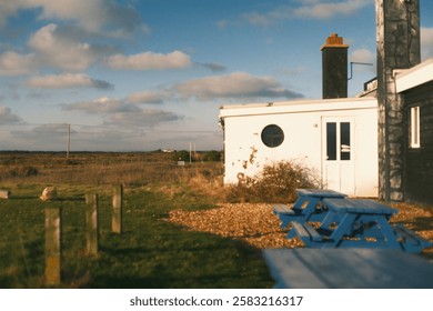 side of a building with circle and square windows while seated on a outdoor bench