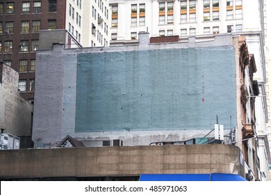 Side Of A Building In New York With Painted-over Advert Space