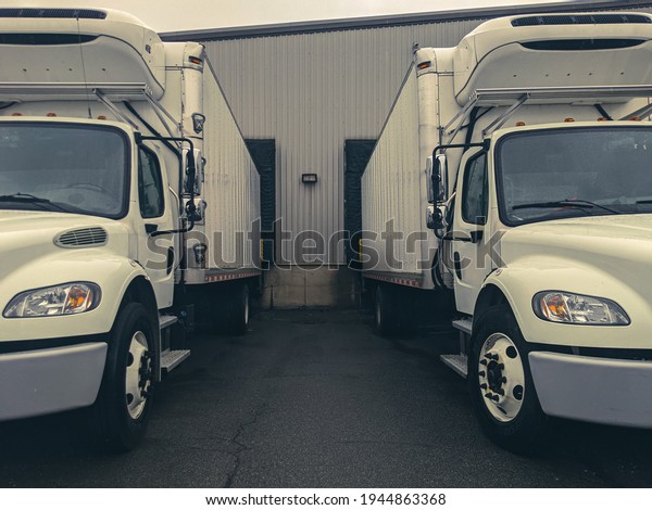 Side by Side Trucks in\
the loading bay