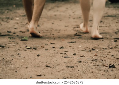 Side by side, two souls walk, grounded and free, tracing an unmarked path where nature meets skin. It is a dance of silence and simplicity, where the journey matters more than the destination. - Powered by Shutterstock