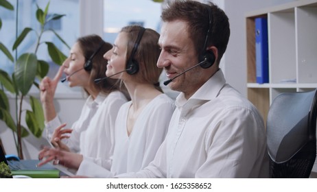 Side close up view of customer support operators with headset acting madly at workplace. Going crazy, funny prank, hilarious. Profession concept, working too long, unlimited working hours