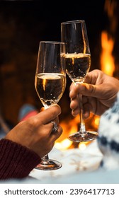 Side close up view of romantic couple celebrating together drinking champagne wine flutes in love and relationship. People man and woman celebrate new year eve in front of a fireplace holiday vacation - Shutterstock ID 2396417713