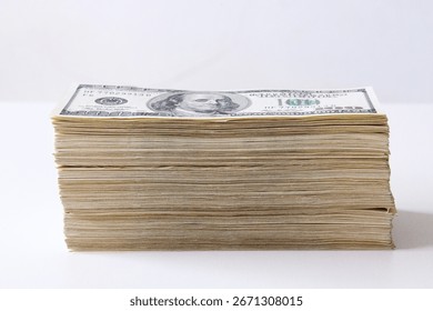 Side closeup of stack of old US hundred dollar bills on white background. Concept of money, finance, savings, profit, investment, wealth and banking.