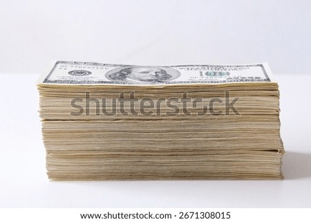 Side closeup of stack of old US hundred dollar bills on white background. Concept of money, finance, savings, profit, investment, wealth and banking.
