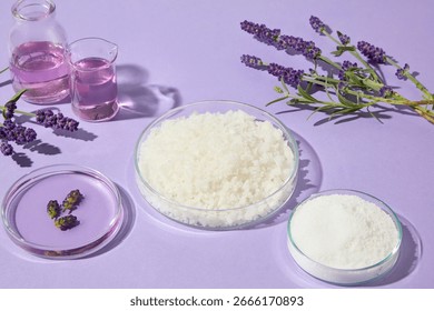 Side composition of lavender sprigs and bath salts in glass dishes on a soft purple background, suitable for aromatherapy, wellness, and skincare designs.