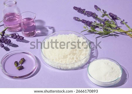 Side composition of lavender sprigs and bath salts in glass dishes on a soft purple background, suitable for aromatherapy, wellness, and skincare designs.
