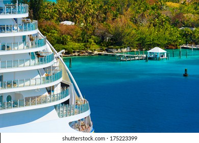 Side Of A Cruise Ship With Trees And Ocean In Background