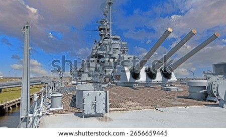 Side deck view of USS Alabama battleship with large cannons