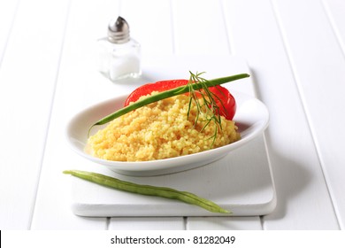 Side dish of couscous garnished with string beans